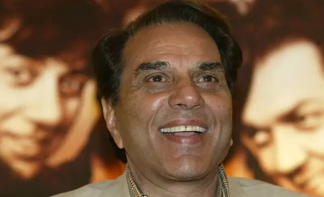 FILE - Bollywood actor and Indian lawmaker Dharmendra reacts during a promotional press conference of his latest film "Apne" in Calcutta, India, Monday, June 25, 2007. (AP Photo/Bikas Das, File)