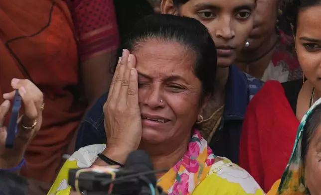 A fan mourns outside a cremation center to pay homage to Bollywood actor Dharmendra who died Monday, in Mumbai India, Monday, Nov. 24, 2025.(AP Photo/Rafiq Maqbool)