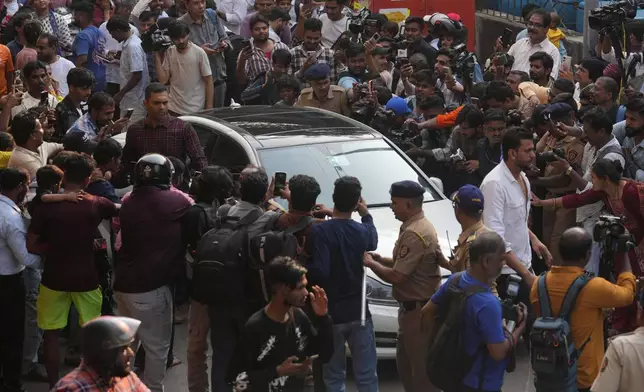 Bollywood actor Govinda drives as he arrives at a cremation center to pay homage to Bollywood actor Dharmendra, in Mumbai India, Monday, Nov. 24, 2025.(AP Photo/Rafiq Maqbool)