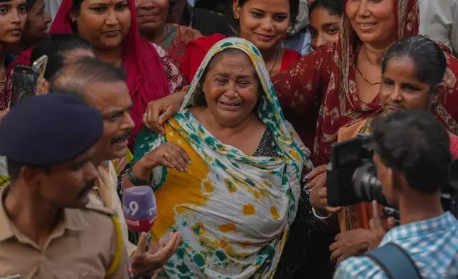 A fan mourns outside a cremation center to pay homage to Bollywood actor Dharmendra, in Mumbai India, Monday, Nov. 24, 2025.(AP Photo/Rafiq Maqbool)