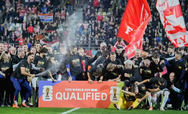 Croat players celebret as they qualified for the World Cup aftre defeating Faroe Islands in Rijeka, Croatia, Friday, Nov. 14, 2025. (AP Photo/Darko Bandic)
