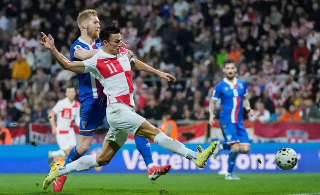 Croatia's Petar Musa scores during a World Cup 2026 group L qualifying soccer match between Croatia and Faroe Islands in Rijeka, Croatia, Friday, Nov. 14, 2025. (AP Photo/Darko Bandic)