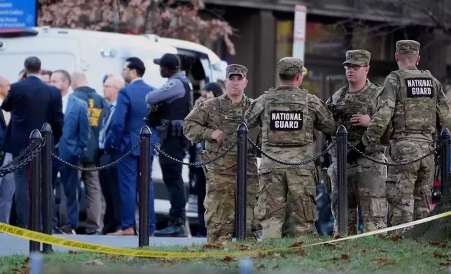 Emergency personnel gather in a cordoned off area where National Guard soldiers were shot near the White House Wednesday, Nov. 26, 2025, in Washington. (AP Photo/Mark Schiefelbein)