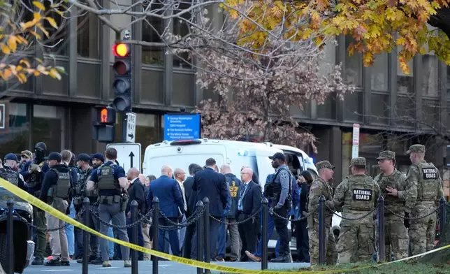 Emergency personnel gather in a cordoned off area where National Guard soldiers were shot near the White House Wednesday, Nov. 26, 2025, in Washington. (AP Photo/Mark Schiefelbein)