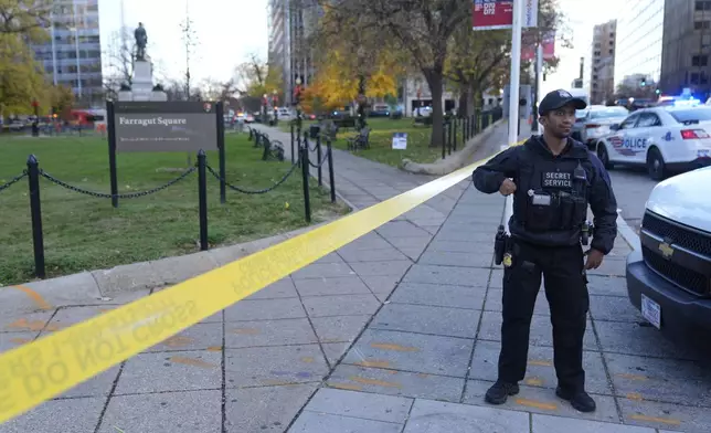 Emergency personnel cordon off an area near where National Guard soldiers appear to have been shot near the White House Wednesday, Nov. 26, 2025, in Washington. (AP Photo/Mark Schiefelbein)