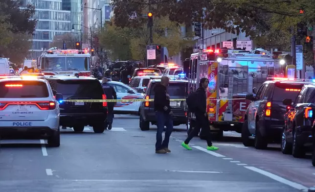 Emergency vehicles gather at a cordoned off area where National Guard soldiers appear to have been shot near the White House Wednesday, Nov. 26, 2025, in Washington. (AP Photo/Mark Schiefelbein)