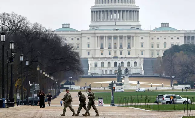 National Guard patrol on the National Mall near the U.S. Capitol, Wednesday, Nov. 26, 2025, in Washington. (AP Photo/Rahmat Gul)