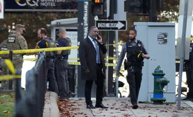 Emergency personnel gather near where National Guard soldiers appear to have been shot near the White House Wednesday, Nov. 26, 2025, in Washington. (AP Photo/Mark Schiefelbein)
