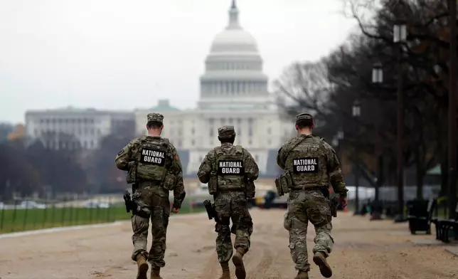National Guard patrol along the National Mall in front of the Capitol, Wednesday, Nov. 26, 2025, in Washington. (AP Photo/Rahmat Gul)