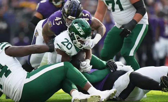 Baltimore Ravens linebacker Mike Green (45) tackles New York Jets running back Breece Hall (20) during the first half of an NFL football game, Sunday, Nov. 23, 2025, in Baltimore. (AP Photo/Stephanie Scarbrough)
