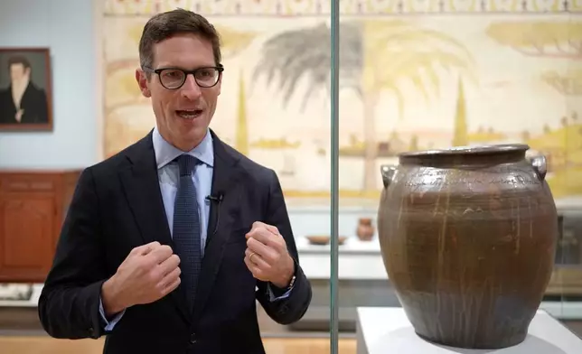 Ethan Lasser, Art of the Americas Chair at the Museum of Fine Arts, describes enslaved potter David Drake's poetry as a "voice resistance," during an interview, Monday, Nov. 10, 2025, in Boston. (AP Photo/Robert F. Bukaty)