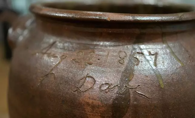 A signed stoneware vessel created by enslaved potter David Drake is seen at the Museum of Fine Arts, Monday, Nov. 10, 2025, in Boston. (AP Photo/Robert F. Bukaty)