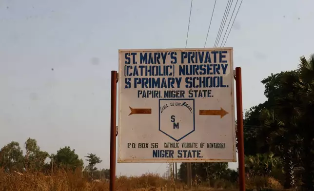 A sign of St. Mary's Catholic Primary and Secondary School is shown, in Papiri community, Nigeria, Friday, Nov. 28, 2025. (AP Photo )