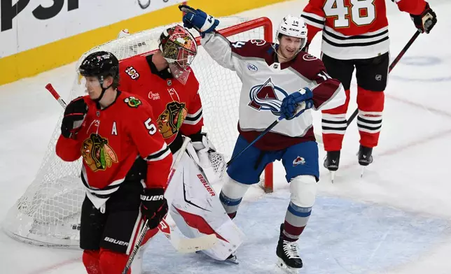 Colorado Avalanche's Jason Polin (14) celebrates after teammate Cale Makar scored a goal during the second period of an NHL hockey game against the Chicago Blackhawks, Sunday, Nov. 23, 2025, in Chicago. (AP Photo/Paul Beaty)