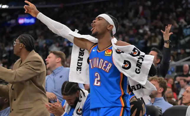 Oklahoma City Thunder guard Shai Gilgeous-Alexander reacts on the bench after a basket during the second half of an NBA basketball game against the Los Angeles Clippers, Tuesday, Nov. 4, 2025, in Los Angeles. (AP Photo/Jayne Kamin-Oncea)