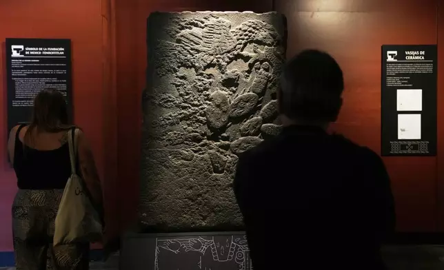 The Teocalli of the Sacred War, the only archaeological piece bearing the carved symbol of Tenochtitlan's founding, an eagle perched on a cactus, is on display at the National Museum of Anthropology in Mexico City, Friday, Nov. 14, 2025. (AP Photo/Claudia Rosel)