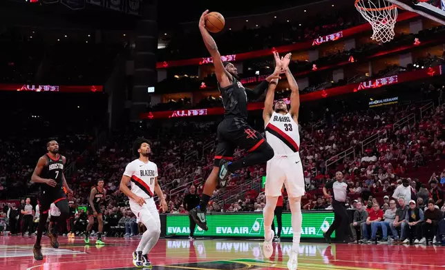 Houston Rockets guard Josh Okogie, center, dunks during the second half of an NBA Cup basketball game against the Portland Trail Blazers in Houston, Friday, Nov. 14, 2025. (AP Photo/Ashley Landis)