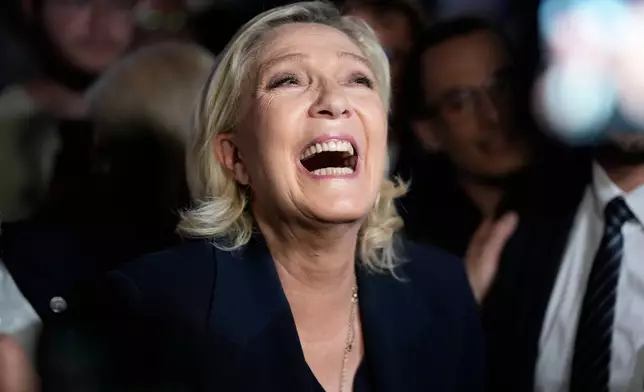 FILE - French far-right leader Marine Le Pen reacts as she meets supporters and journalists after the release of projections based on the actual vote count in select constituencies , Sunday, June 30, 2024 in Henin-Beaumont, northern France. (AP Photo/Thibault Camus, File)