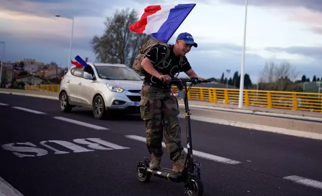 FILE - Supporters of French far-right leader Marine Le Pen leave after a campaign rally in Perpignan, southern France, Thursday, April 7, 2022. (AP Photo/Joan Mateu Parra, File)