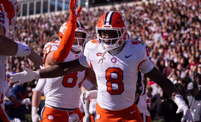 Clemson running back Adam Randall (8) celebrates after a touchdown against the South Carolina during the first half of an NCAA college football game, Saturday, Nov. 29, 2025, in Columbia, S.C. (AP Photo/Scott Kinser)