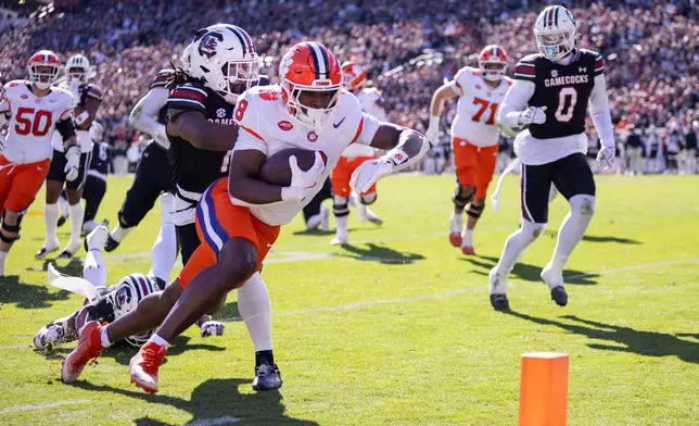 Clemson running back Adam Randall (8) runs in for a touchdown against the South Carolina during the first half of an NCAA college football game, Saturday, Nov. 29, 2025, in Columbia, S.C. (AP Photo/Scott Kinser)