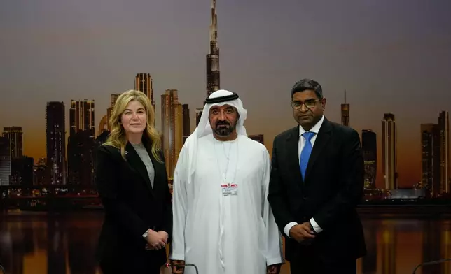 Stephanie Pope, President and CEO of Boeing Commercial Airplanes, left, Sheikh Ahmed bin Saeed Al Maktoum, President, Dubai Civil Aviation Authority and Chairman of Emirates airlines, centre, and Mahendra Nair, group vice-president GE Aerospace, pose during a press conference on the opening day of the Dubai Air Show, United Arab Emirates, Monday, Nov. 17, 2025. (AP Photo/Altaf Qadri)