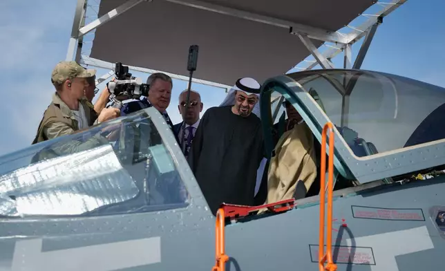 Sheikh Mohammed bin Zayed Al Nahyan, the president of the United Arab Emirates and the ruler of Abu Dhabi, checks the cockpit of Russia's SU57E fighter jet at Russian pavilion during the opening day of the Dubai Air Show, United Arab Emirates, Monday, Nov. 17, 2025. (AP Photo/Altaf Qadri)