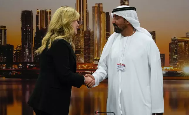 Stephanie Pope, President and CEO of Boeing Commercial Airplanes, left, and Sheikh Ahmed bin Saeed Al Maktoum, President, Dubai Civil Aviation Authority and Chairman of Emirates airlines, shake hands after signing an agreement to order 65 additional Boeing 777X aircrafts during a press conference on the opening day of the Dubai Air Show, United Arab Emirates, Monday, Nov. 17, 2025. (AP Photo/Altaf Qadri)