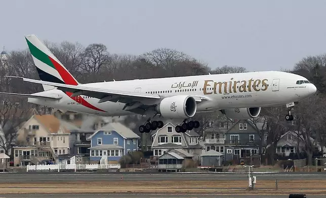 FILE - An Emirates Airlines Boeing 777 lands at Logan International Airport in Boston, March 10, 2014. (AP Photo/Michael Dwyer, File)