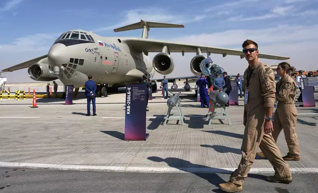 U.S. Air Force airmen walk past a Russian Ilyushin Il-76 transport plane at the Dubai Air Show in Dubai, United Arab Emirates, Monday, Nov. 17, 2025. (AP Photo/ Fatima Shbair)