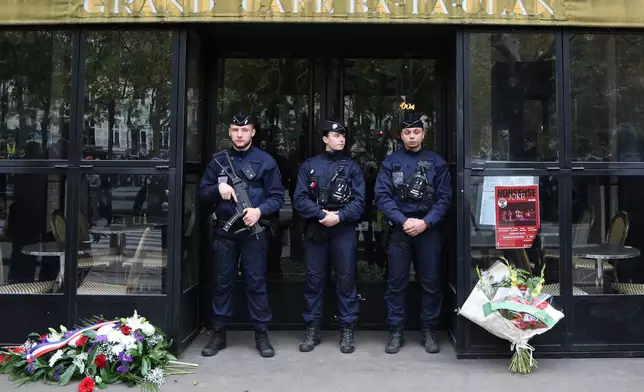 Police officers stand guard near the Bataclan concert hall, Thursday Nov. 13, 2025 in Paris as part of ceremonies marking the 10th anniversary of terrorist attacks that killed 132 people and injured hundreds. (Ludovic Marin, Pool photo via AP)