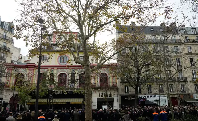 People and officials gather outside the Bataclan concert hall as Paris is marking the 10th anniversary of terrorist attacks that killed 132 people and injured hundreds, Thursday, Nov. 13, 2025 in Paris. (AP Photo/Michel Euler)