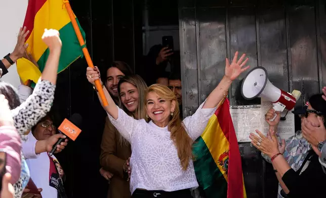 Bolivia's former President Jeanine Anez walks free from the Miraflores jail after the Supreme Court annulled her 10-year prison sentence in La Paz, Bolivia, Thursday, Nov. 6, 2025. (AP Photo/Juan Karita)