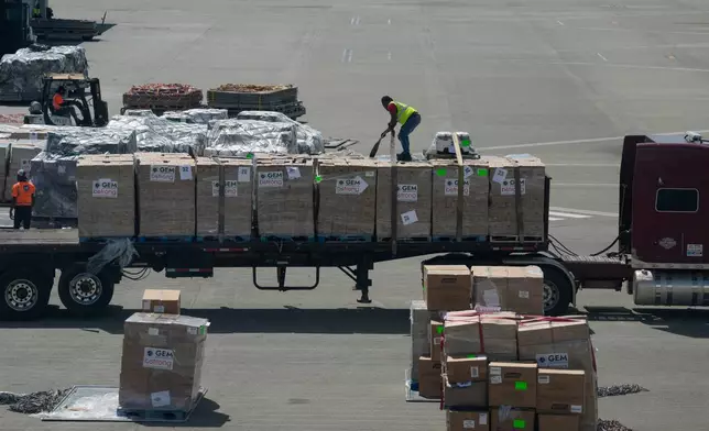 A worker unloads humanitarian aid at the Norman Manley International Airport in Kingston, Jamaica, Saturday, Nov. 1, 2025, in the aftermath of Hurricane Melissa. (AP Photo/Matias Delacroix)