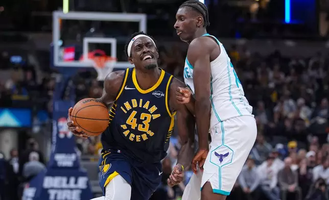 Indiana Pacers forward Pascal Siakam (43) is fouled as he drives past Charlotte Hornets forward Moussa Diabate (14) during the second half of an NBA basketball game in Indianapolis, Wednesday, Nov. 19, 2025. (AP Photo/Michael Conroy)