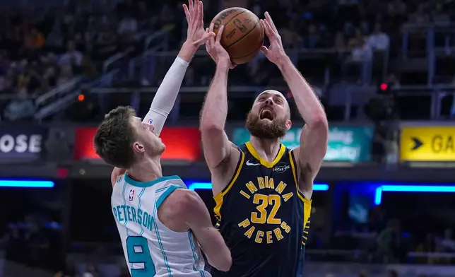 Indiana Pacers center Jay Huff (32) shoots ver Charlotte Hornets forward Drew Peterson (9) during the second half of an NBA basketball game in Indianapolis, Wednesday, Nov. 19, 2025. (AP Photo/Michael Conroy)