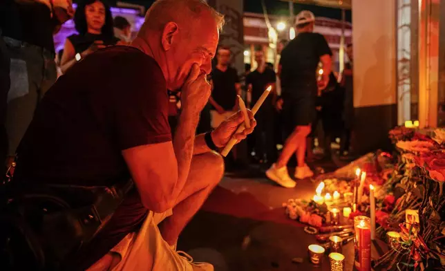 Denis Ramsey cries during a vigil for the victims of an overnight crash of a vehicle involved in a high speed chase, which caused several deaths and multiple injuries at Bradley's on 7th, a popular LGBTQ+ nightclub, Saturday, Nov. 8, 2025, in Tampa, Fla. (Martha Asencio-Rhine/Tampa Bay Times via AP)
