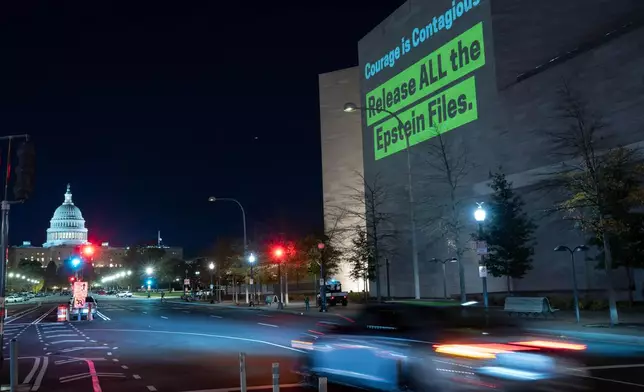 A World Without Exploitation projection is seen on the wall of the National Gallery of Art calling on Congress to vote yes on the Epstein Files Transparency Act in Washington, Monday, Nov. 17, 2025. (AP Photo/Jose Luis Magana)