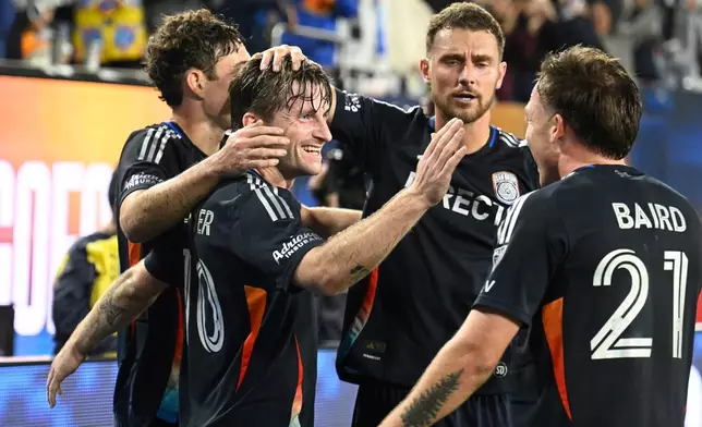 San Diego FC midfielder Anders Dreyer (10) is congratulated after scoring during the second half of MLS soccer's Western Conference semifinal against Minnesota United Monday, Nov. 24, 2025, in San Diego. (AP Photo/Denis Poroy)