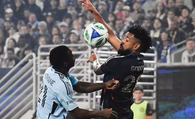 San Diego FC midfielder Anibal Godoy (20), right, fights for the ball with Minnesota United forward Bongokuhle Hlongwane (21) during the first half of MLS soccer's Western Conference semifinal Monday, Nov. 24, 2025, in San Diego. (AP Photo/Denis Poroy)