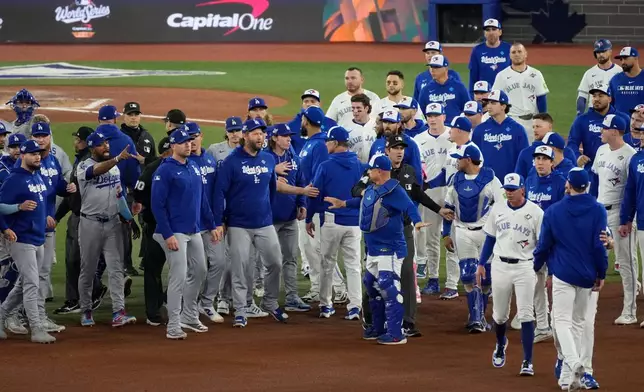 The Los Angeles Dodgers and the Toronto Blue Jays benches clear after Blue Jays' Andrés Giménez was hit by a pitch during the fourth inning in Game 7 of baseball's World Series, Saturday, Nov. 1, 2025, in Toronto. (AP Photo/Ashley Landis)