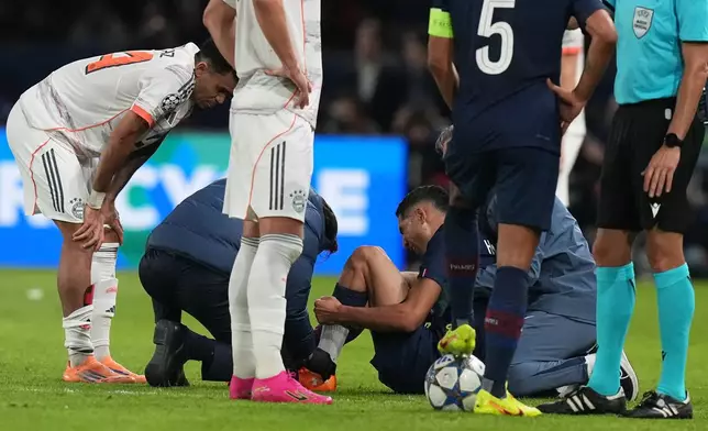 PSG's Achraf Hakimi sits on the ground injured during the Champions League opening phase soccer match between Paris Saint-Germain and Bayern Munich in Paris, France, Tuesday, Nov. 4, 2025. (AP Photo/Thibault Camus)