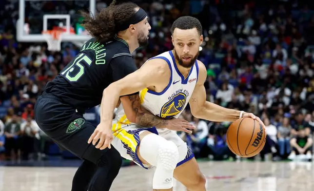 Golden State Warriors guard Stephen Curry (30) dribbles around New Orleans Pelicans guard Jose Alvarado (15) during the second quarter of an NBA basketball game, Sunday, Nov. 16, 2025, in New Orleans. (AP Photo/Butch Dill)