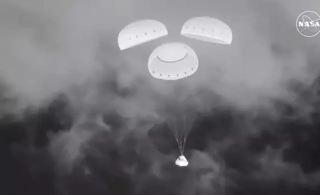 FILE - In this image from video provided by NASA, the empty Boeing Starliner capsule floats down towards White Sands Missile Range in New Mexico late Sept. 6, 2024, after undocking from the International Space Station. (NASA via AP, File)
