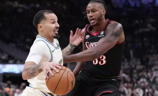 Milwaukee Bucks' Cole Anthony tries to get past Philadelphia 76ers' Jabari Walker during the first half of an NBA basketball game Thursday, Nov. 20, 2025, in Milwaukee. (AP Photo/Morry Gash)