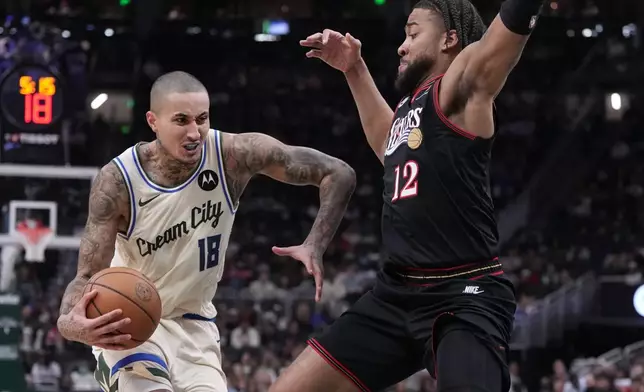 Milwaukee Bucks' Kyle Kuzma tries to get by Philadelphia 76ers' Trendon Watford during the first half of an NBA basketball game Thursday, Nov. 20, 2025, in Milwaukee. (AP Photo/Morry Gash)
