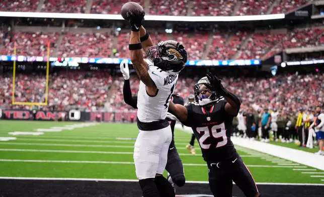 Jacksonville Jaguars wide receiver Parker Washington (11) scores a touchdown against Houston Texans safety M.J. Stewart (29) during an NFL football game, Sunday, Nov. 9, 2025, in Houston. (AP Photo/Eric Christian Smith)