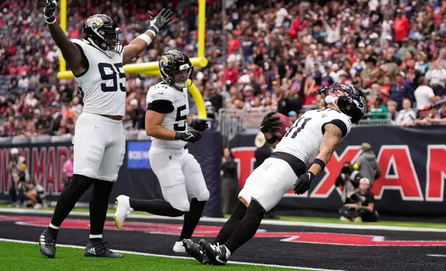 Jacksonville Jaguars wide receiver Parker Washington (11) scores a touchdown after a punt return during an NFL football game, Sunday, Nov. 9, 2025, in Houston. (AP Photo/Eric Christian Smith)