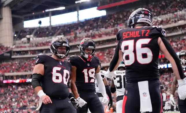 Houston Texans tight end Dalton Schultz (86) celebrates scoring a touchdown during the second half of an NFL football game against the Jacksonville Jaguars, Sunday, Nov. 9, 2025, in Houston. (AP Photo/Ashley Landis)
