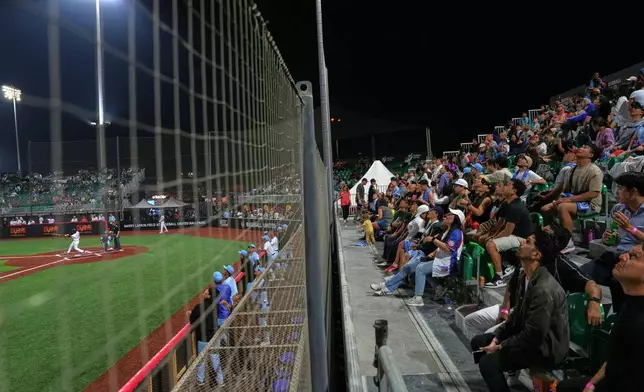 Karachi fans react during the league's opening baseball game at the new Barry Larkin Field in Ud al-Bayda, on the outskirts of Dubai, United Arab Emirates, Friday, Nov. 14, 2025. (AP Photo/Fatima Shbair)